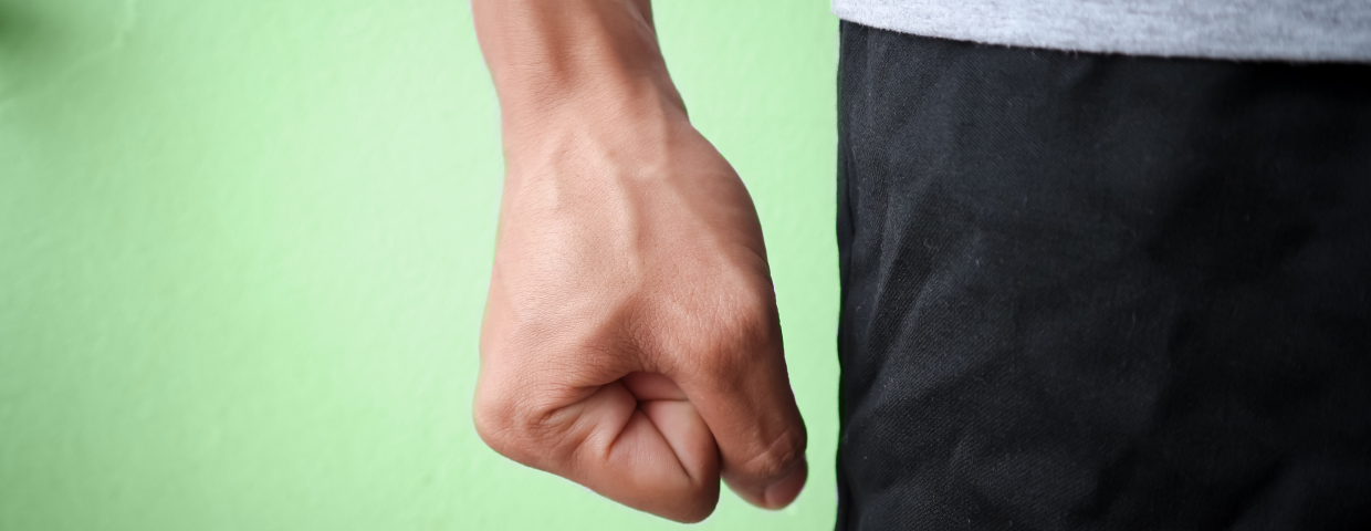 An image of a clenched fist on a green background.